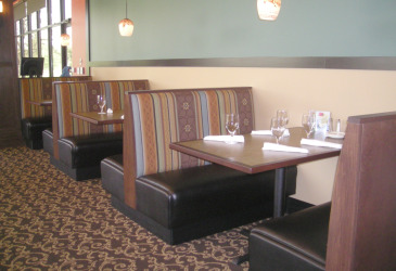 Restaurant booths with silverware and glasses